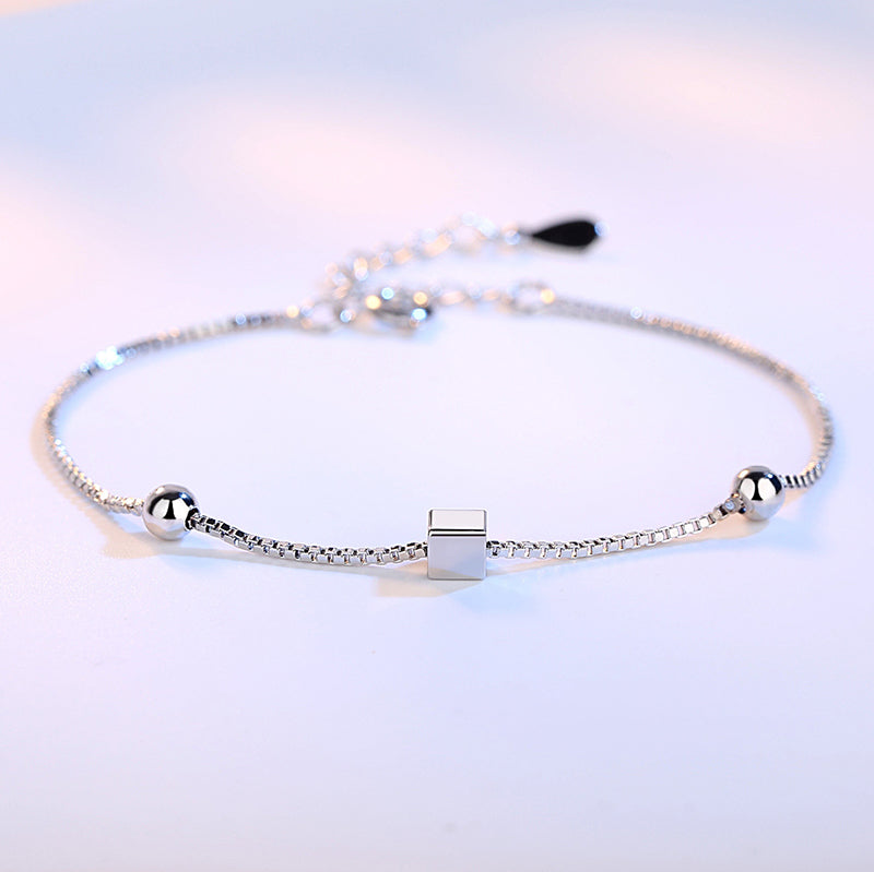 Square handmade bracelet with box chain design displayed in a sleek bracelet box, showcasing detailed craftsmanship.