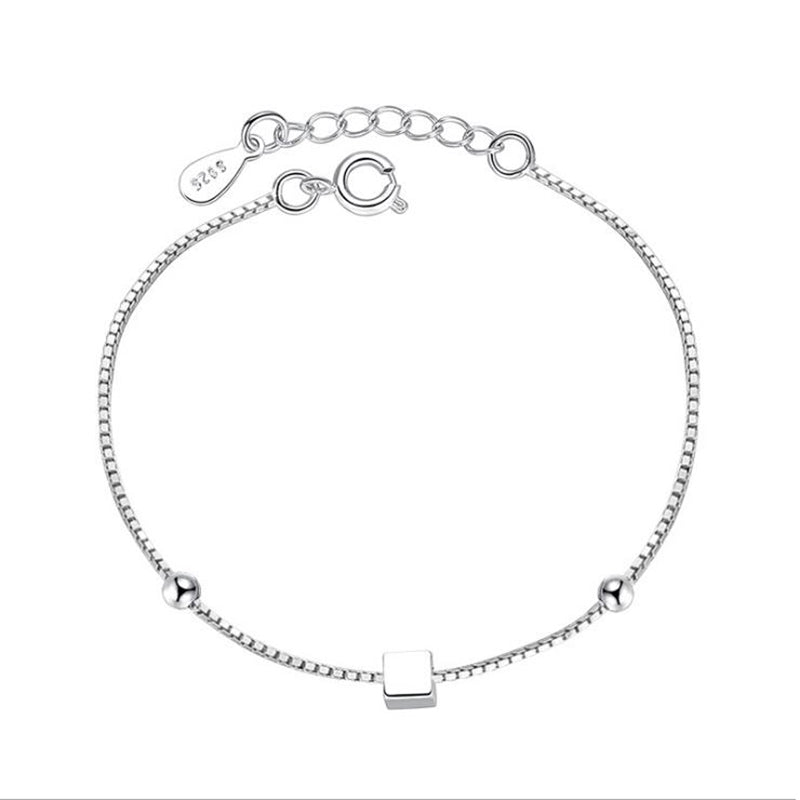 Square handmade bracelet on a bracelet box chain, showcasing intricate design and craftsmanship.