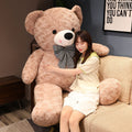 Large plush teddy bear with a bow tie, soft and cuddly, perfect for hugging and gift-giving