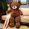 Large plush teddy bear with a bow tie, soft and cuddly, perfect for hugging and gifting.