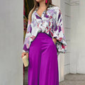 Vibrant abstract print blouse and wide-leg trousers set, stylish women's fashion outfit with bold colorful patterns.