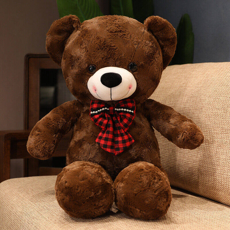 Giant plush teddy bear with a bow tie, soft and cuddly, perfect for gifting or home decor.