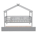 Twin size wooden house bed with attached trundle, featuring a cozy design and sturdy construction for kids' bedroom decor.