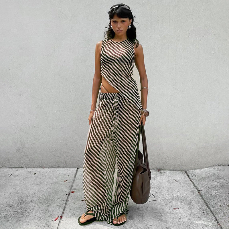 Women's sleeveless diagonal stripes see-through irregular top suit on beach.