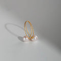 Close-up of a double freshwater pearl open ring featuring two elegant, lustrous pearls on a sleek silver band.