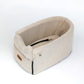 Luxury central console dog car seat with padded interior and secure straps for comfortable pet travel in a vehicle.