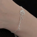 Personalized birthday flower birthstone bracelet with floral charm and birthstone accent, crafted in sterling silver.