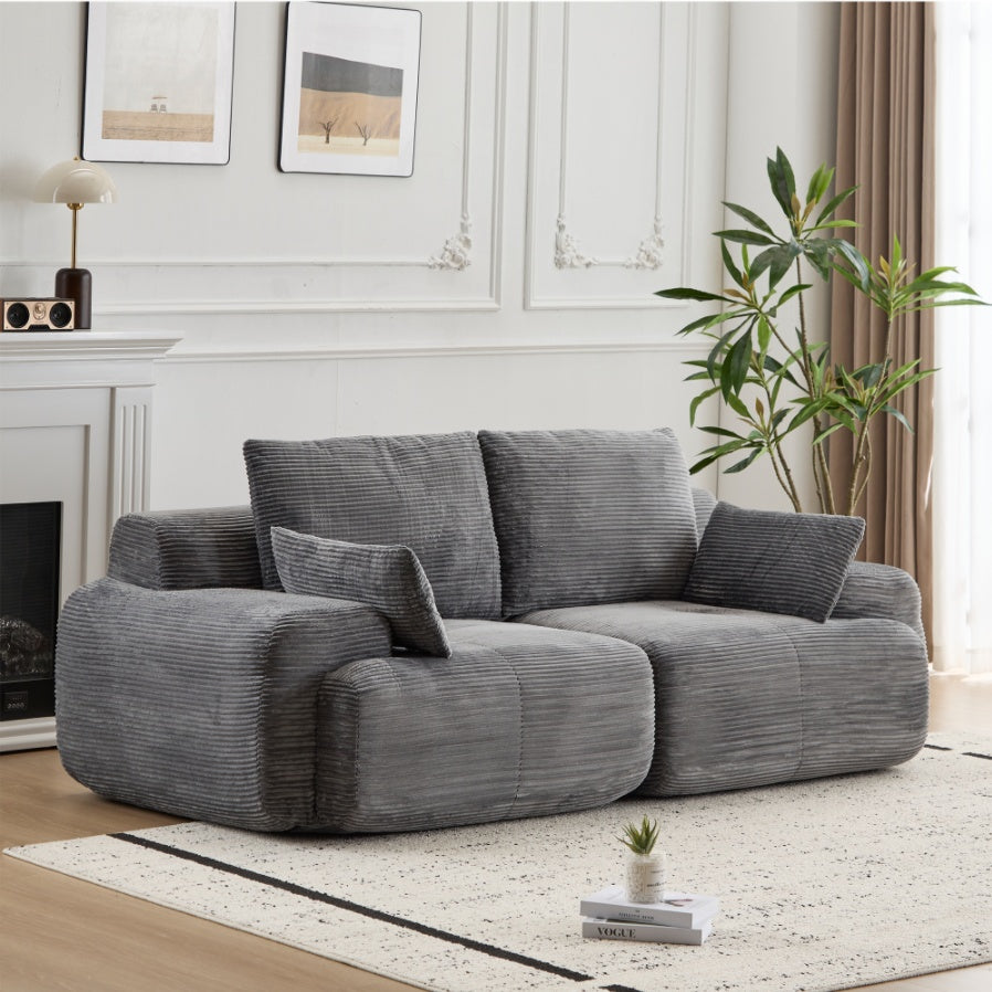 Soft beige luxury wide-wale corduroy cloud couch with plush cushions and curved design, ideal for modern living rooms.