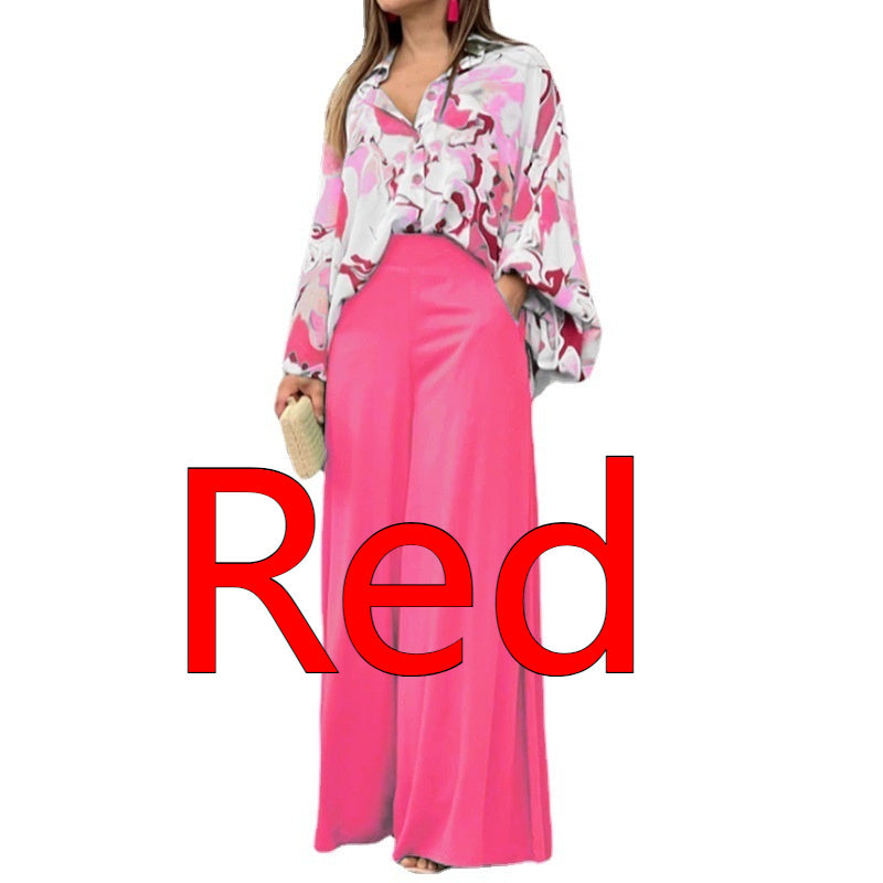 Vibrant abstract print blouse and wide-leg trousers set with colorful pattern and flowing fabric, perfect for stylish casual wear.
