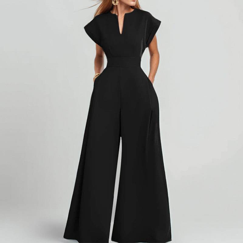 Architectural V-neck wide-leg jumpsuit in neutral fabric, featuring a sleek silhouette and modern design.
