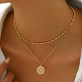 Silver chain paired with a crystal medal pendant, showcasing a delicate jewelry piece with sparkling crystal accents.