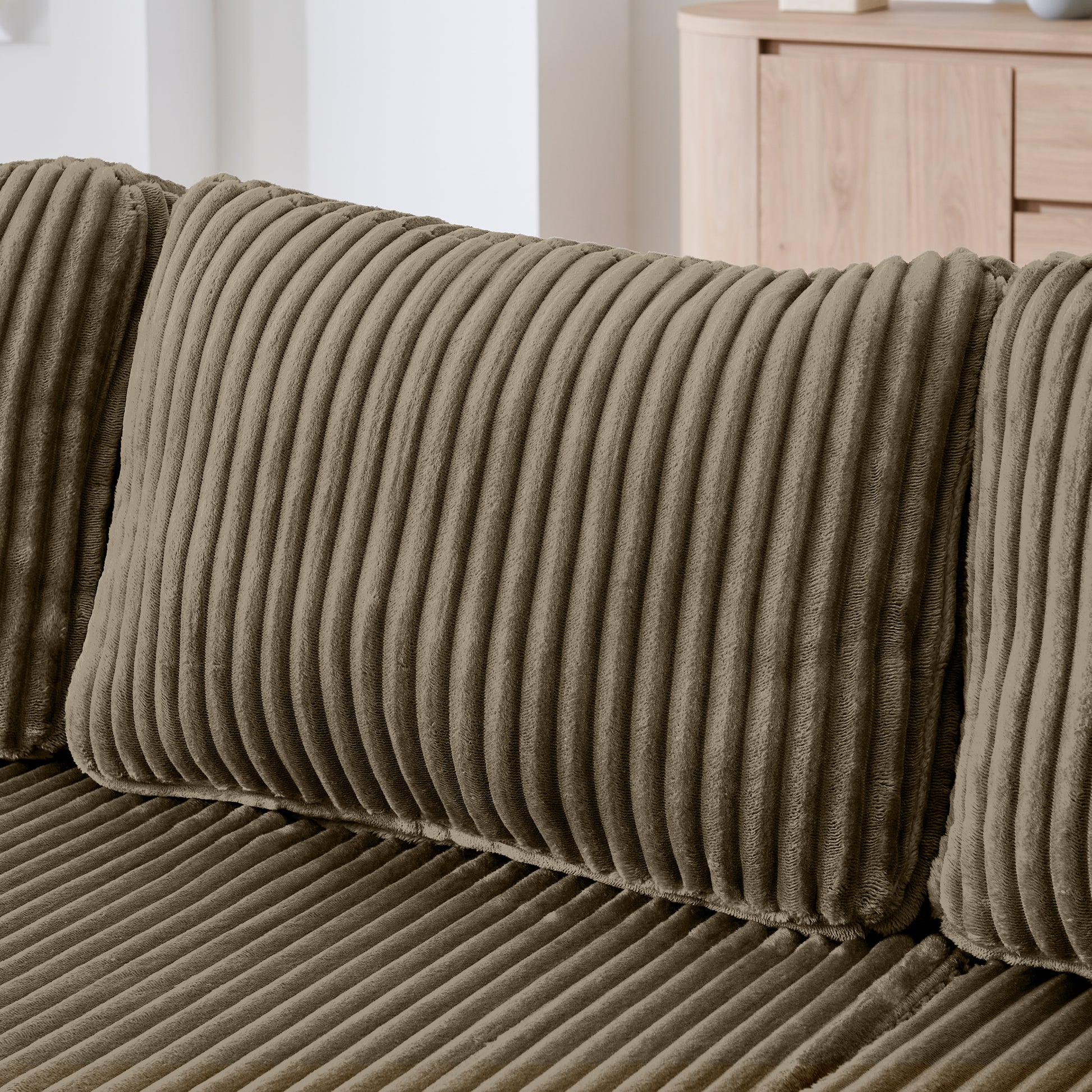 U-shaped modern sectional sofa with neutral upholstery, showcasing a spacious, contemporary design for living room comfort.