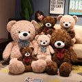Large plush teddy bear with a bow tie, soft fur, and friendly expression, ideal as a cuddly gift or decorative plush toy.