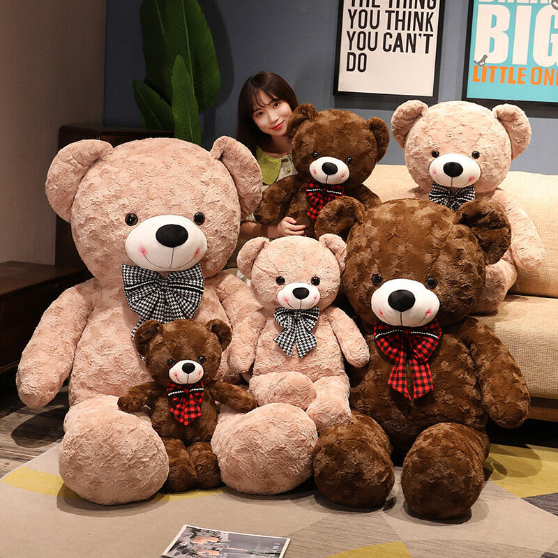 Large plush teddy bear with a bow tie, soft fur, and friendly expression, ideal as a cuddly gift or decorative plush toy.