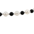 Natural freshwater pearl and black agate necklace with a cross pendant, featuring elegant gemstone details.