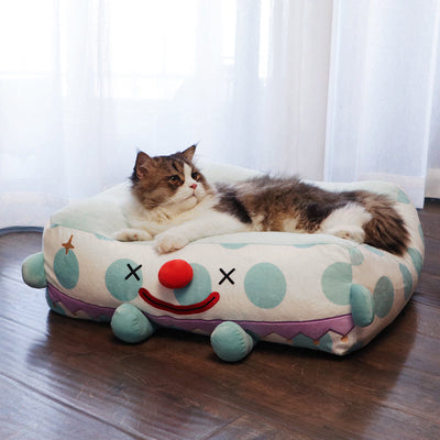 Clown Pet Sleeps In A Cozy Pet Bed null