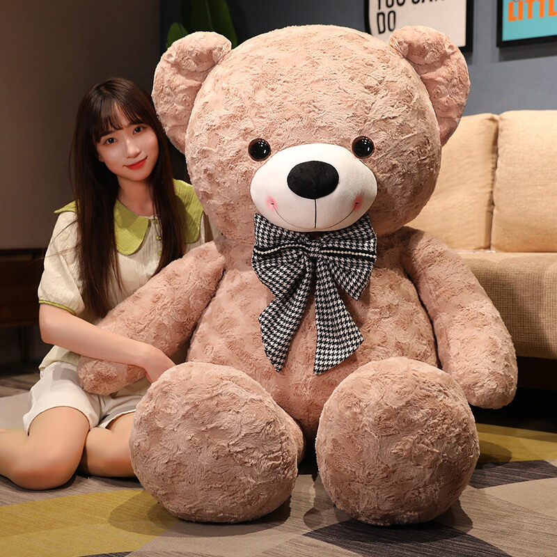 Large plush teddy bear with a bow tie, soft and cuddly, perfect for hugging and decorative display