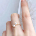 Close-up of a double freshwater pearl open ring showcasing its elegant design and polished silver band.