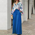 Vibrant abstract print blouse and wide-leg trousers set featuring bold colors and relaxed fit, perfect for stylish casual wear.