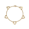Gold plated open heart station chain bracelet with delicate links and heart charms, perfect for elegant jewelry styling.