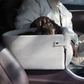 Luxury central console dog car seat shown in a neutral setting, designed for comfort and safety during car travel.