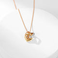 Square three-color ring necklace with interlocking clavicle chain, showcasing layered geometric jewelry design.