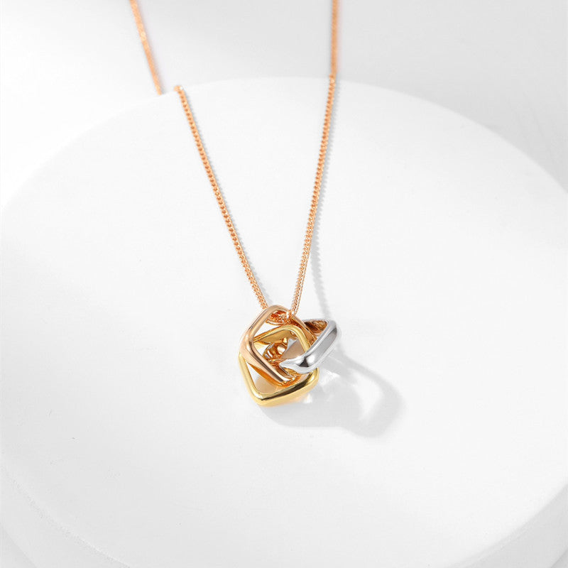 Square three-color ring necklace with interlocking clavicle chain, showcasing layered geometric jewelry design.