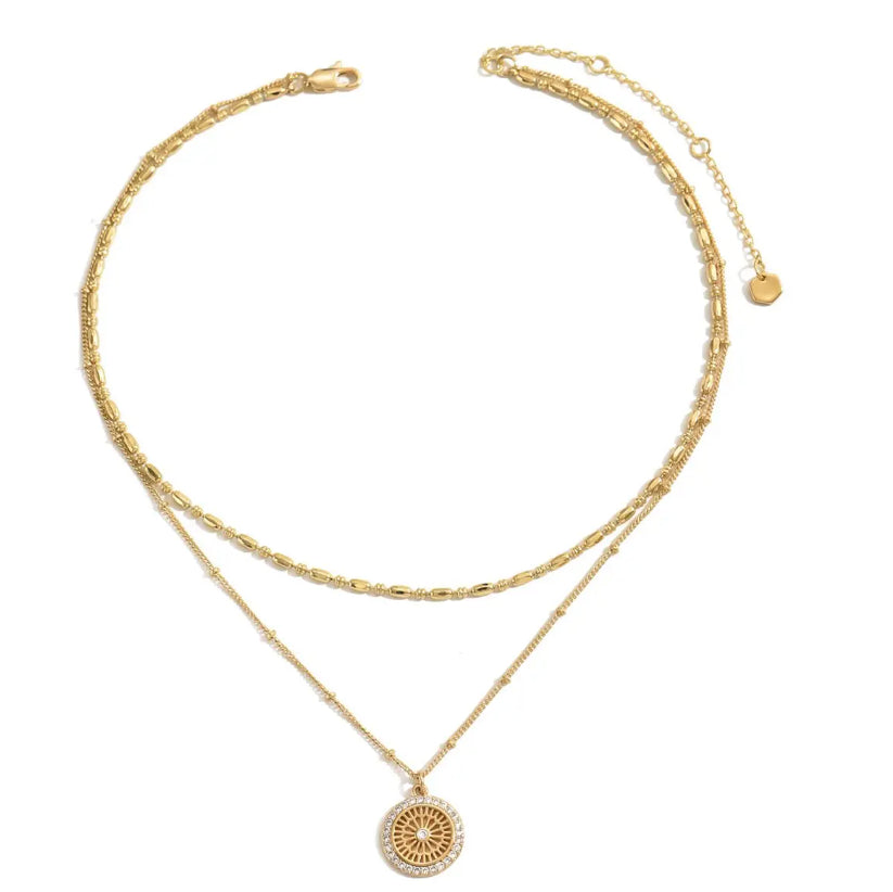 Silver chain paired with a crystal medal pendant, showcasing a delicate jewelry piece with a sparkling crystal in a detailed setting.