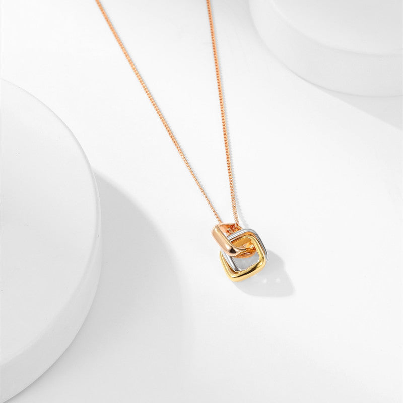 Square three-color ring necklace featuring interlocking clavicle chain design, showcasing vibrant metal rings on a delicate chain.
