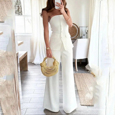 Off-shoulder sleeveless white pantsuit with buttons in a slim-fit design.