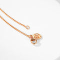 Square three-color ring necklace with interlocking clavicle chain, showcasing a modern layered jewelry design.