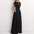 Architectural V-Neck Wide-Leg Jumpsuit in neutral fabric, featuring a stylish V-neckline and flowing wide-leg design.
