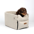 Luxury central console dog car seat with plush padding and safety straps for comfortable pet travel in vehicles.