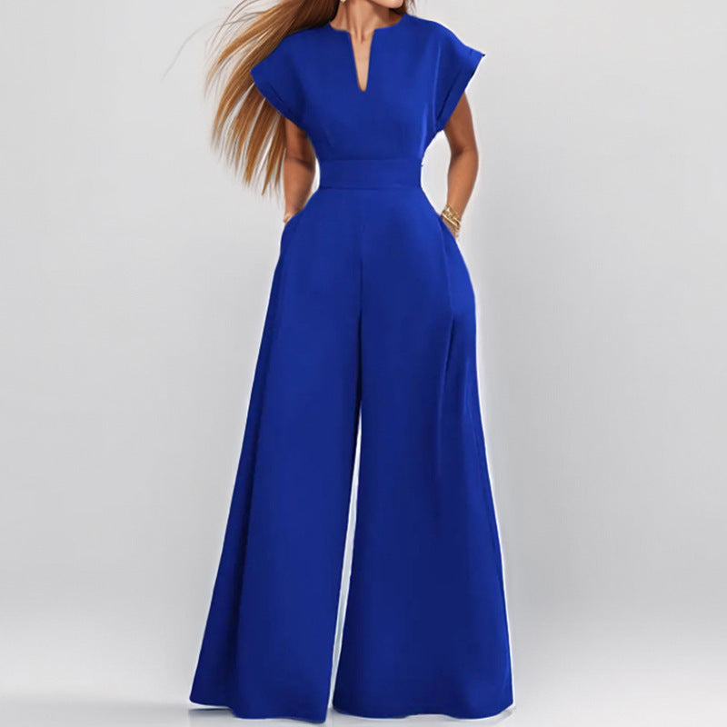 Architectural V-Neck Wide-Leg Jumpsuit in neutral fabric, featuring a relaxed fit, V-neckline, and wide-leg silhouette on model.