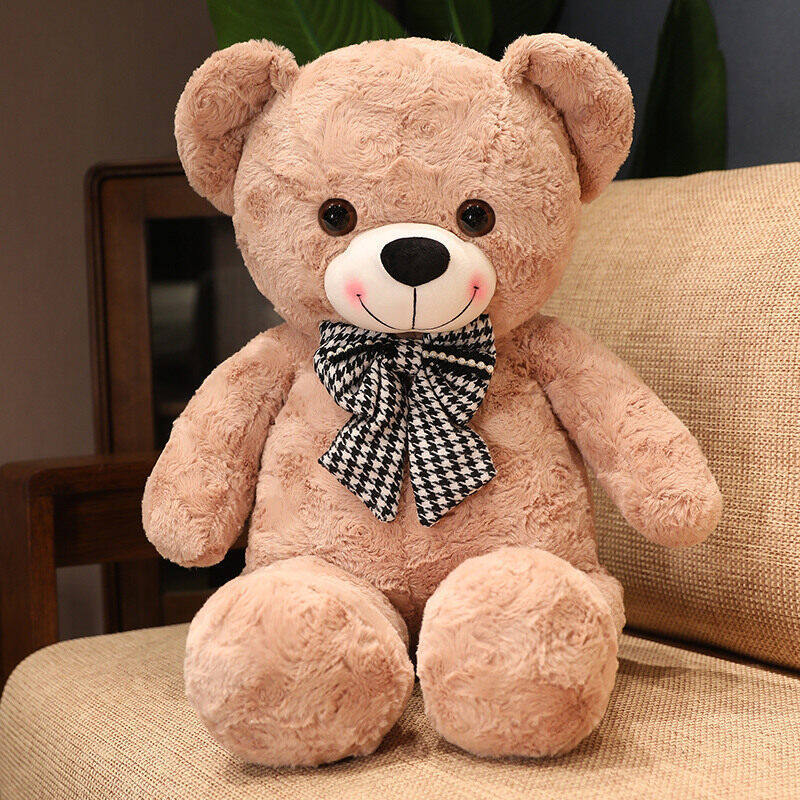 Giant plush teddy bear with a bow tie, soft and cuddly, perfect for gift-giving or as a decorative teddy bear.