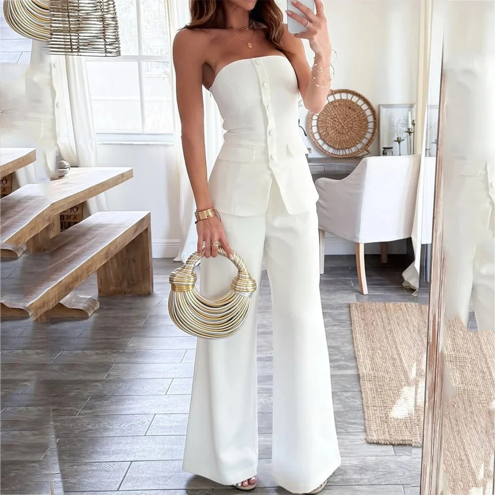 Off-shoulder sleeveless white pantsuit with buttons in a slim-fit design.