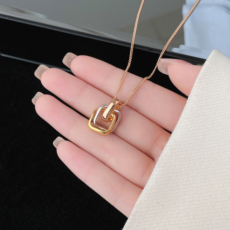 Square three-color ring necklace with interlocking clavicle chain, showcasing layered geometric jewelry design